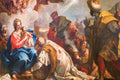Painting of the Adoration of the Magi with three wise men kneeling before Mary and Jesus.