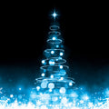 Blue Christmas tree with lights on a dark background