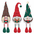 Three festive Christmas gnome illustrations standing side by side on a plain white background. Each gnome has a tall pointed hat, a white beard, striped legs, and holiday-themed accessories including candy canes, gingerbread cookies, and a mug.