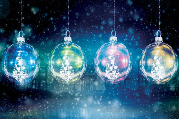 Four colorful Christmas ornaments hanging against a dark snowy background