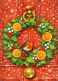 A festive Christmas wreath hanging on a red paneled door, decorated with green holly leaves, red berries, white berries, orange slices, a small robin bird, a gold bell, and a red bow. Snowflakes are visible in the background.