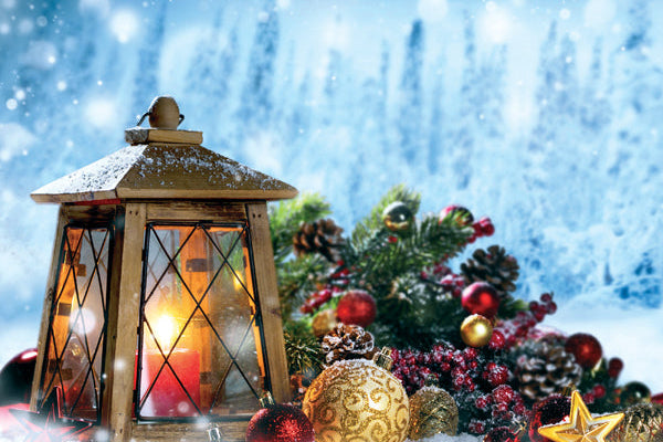 Decorative Christmas scene with a lantern, ornaments, and a snowy background