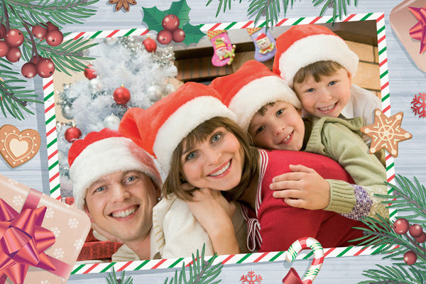 Family posing for a photo with Christmas decorations around them