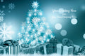Christmas card with a blue Christmas tree, presents, and snowflakes on a dark blue background.