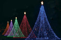 Decorative Christmas trees made of lights on a dark background