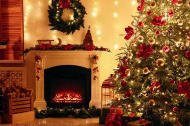 A cozy Christmas living room scene with a decorated evergreen tree on the right, a lit fireplace with festive mantel decorations on the left, and warm string lights throughout the room.