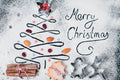 Decorative Christmas tree made of cookies and spices with 'Merry Christmas' text on a snowy background.