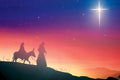 Silhouettes of the Holy Family with a donkey under a starry night sky.