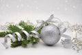 Silver glitter baubles with ribbon and foliage