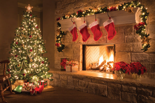 Cozy Christmas living room with decorated tree, stockings, and fireplace.
