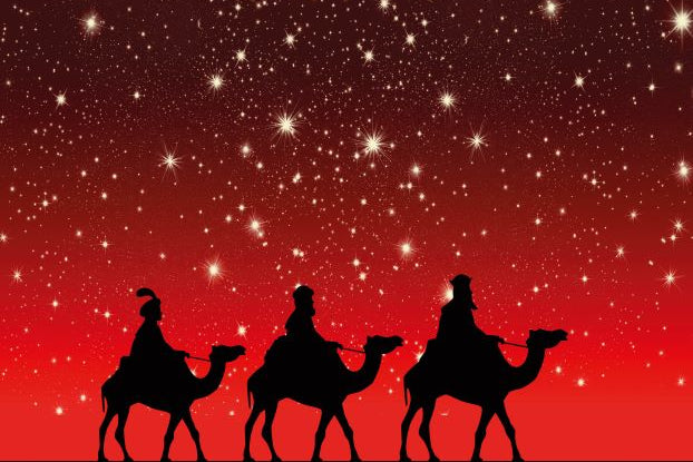 Silhouettes of three wise men on camels against a red night sky with stars.