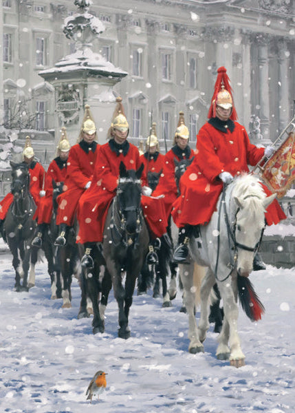 Horseback riders in red uniforms and gold hats in a snowy setting with a building in the background.