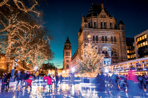 Ice skating rink in front of a large building with Christmas lights