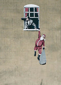 Street art of a man in a suit looking out a window at a person in a Santa Claus outfit on a beige wall.