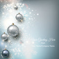 Decorative card with silver Christmas balls and snowflakes on a light blue background.