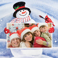Collage of a snowman and a family photo with children wearing Santa hats on a snowy background.